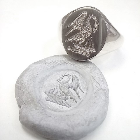 Heraldic bird feeding chicks silver signet ring